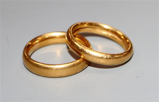 A 22ct gold wedding band and one other yellow metal wedding band.